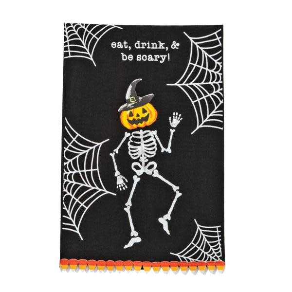 Flour sack hand towel with mini pom trim featuring a black skeleton pattern on white cotton.