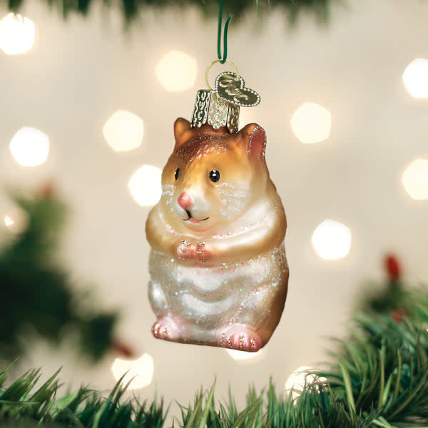 Green ceramic hamster ornament with textured fur detail standing on a small base.