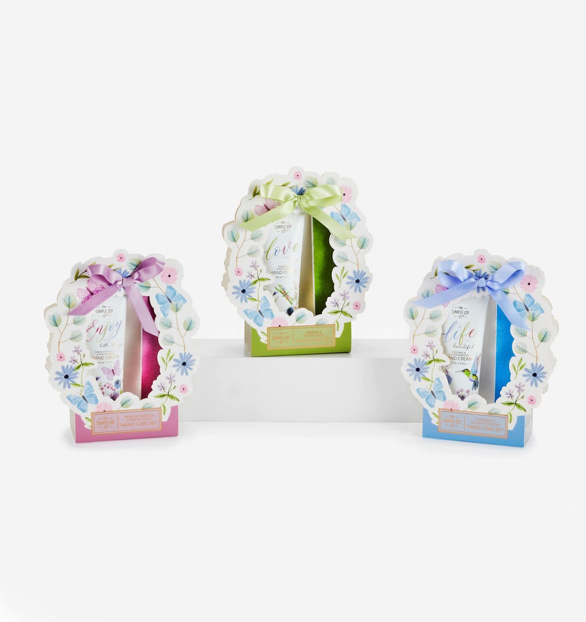 Gift box containing scented hand cream and a glittery nail file with floral ribbon.