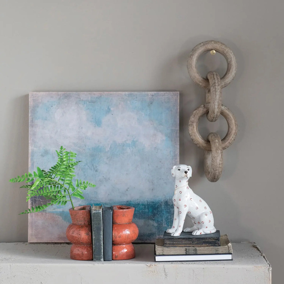 Hand-painted ceramic dog figurine with antique crackle finish in cream color featuring rust-colored spots.