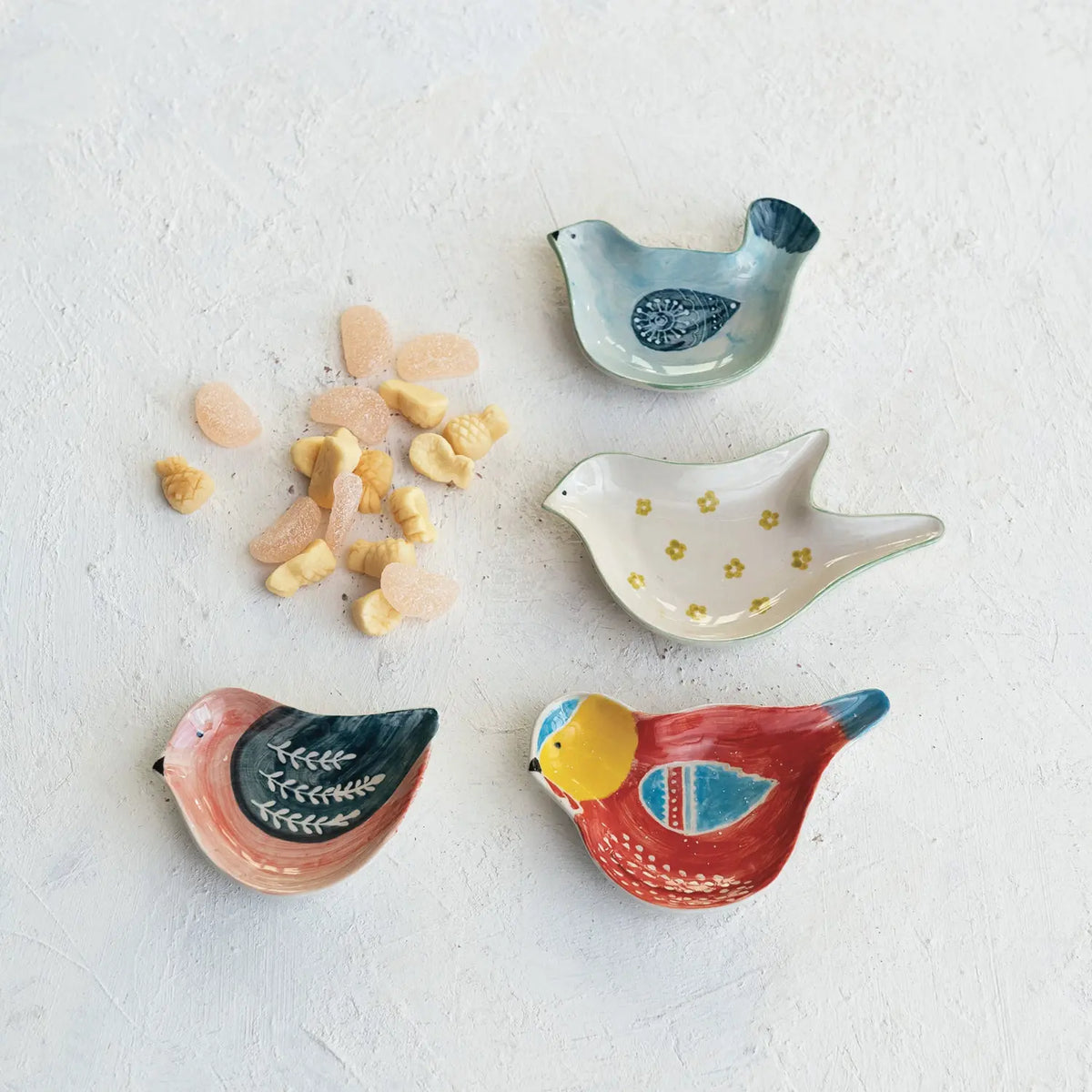 Hand-painted stoneware bird-shaped dish in earthy tones with a whimsical silhouette.
