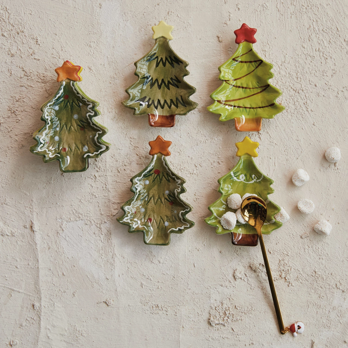 Hand-painted stoneware Christmas tree dish with a star accent in festive colors.