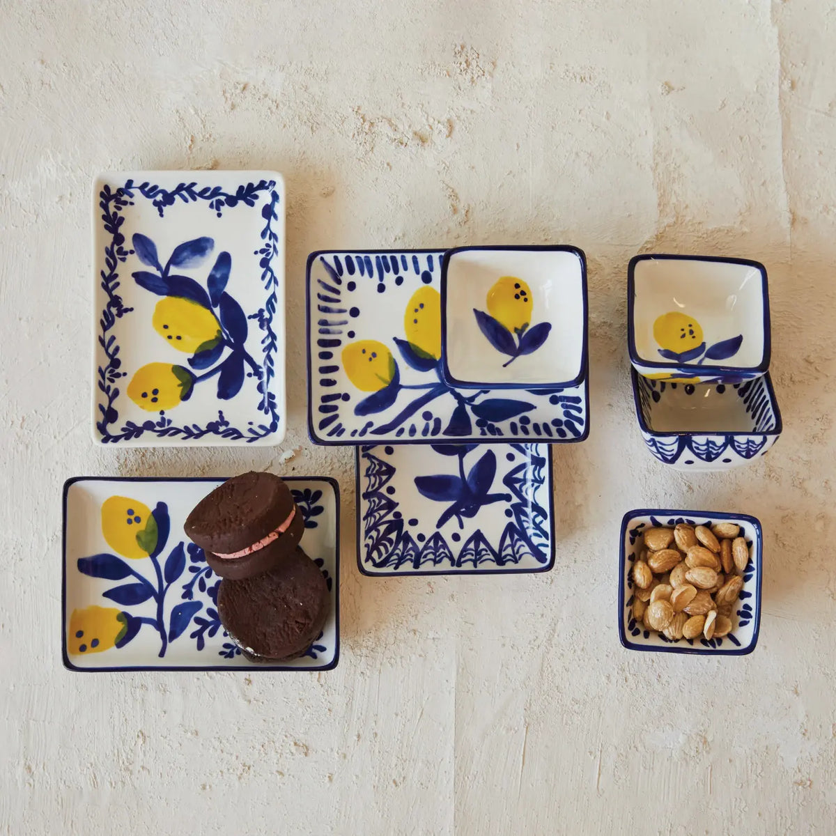 Hand-painted stoneware dish with yellow lemon motifs on a white background