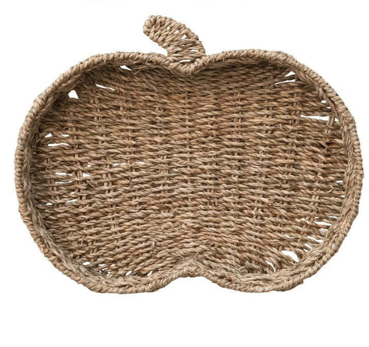 Hand-woven seagrass tray shaped like a pumpkin with neutral tones