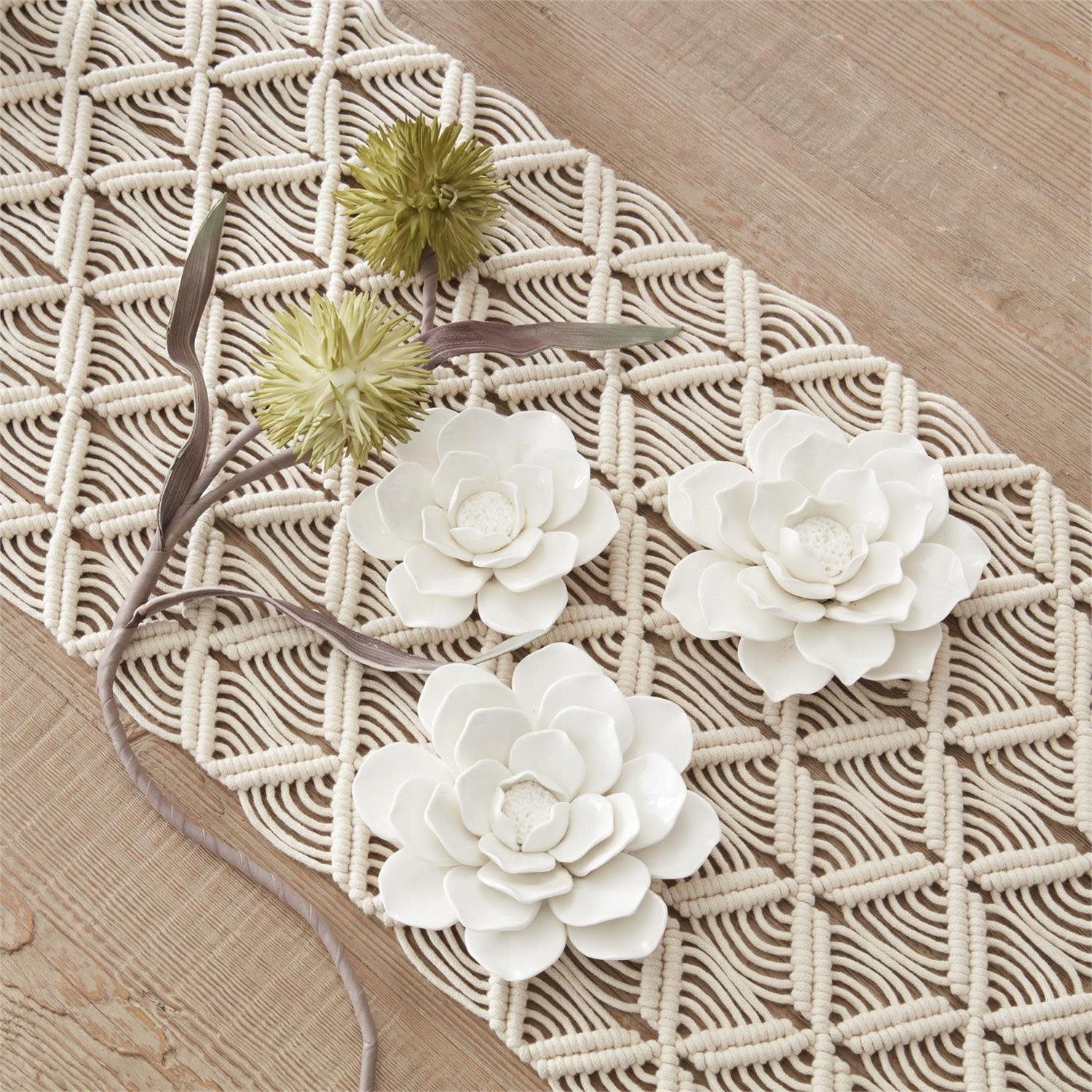 Handcrafted glossy white ceramic flower wall hanging with sleek modern silhouette