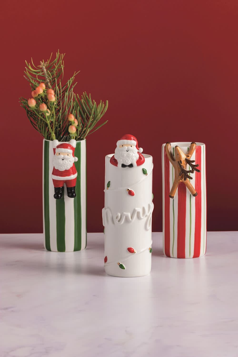 Hand-painted stoneware Bud Vase with hanging Santa attachment in festive holiday colors.
