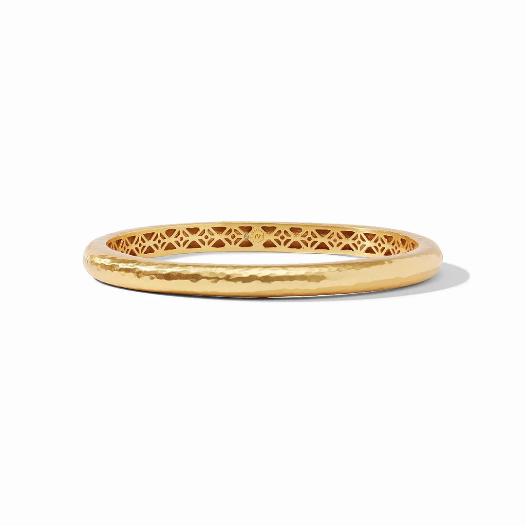 Havana bangle in gold with hand-hammered finish and geometric piercework interior.