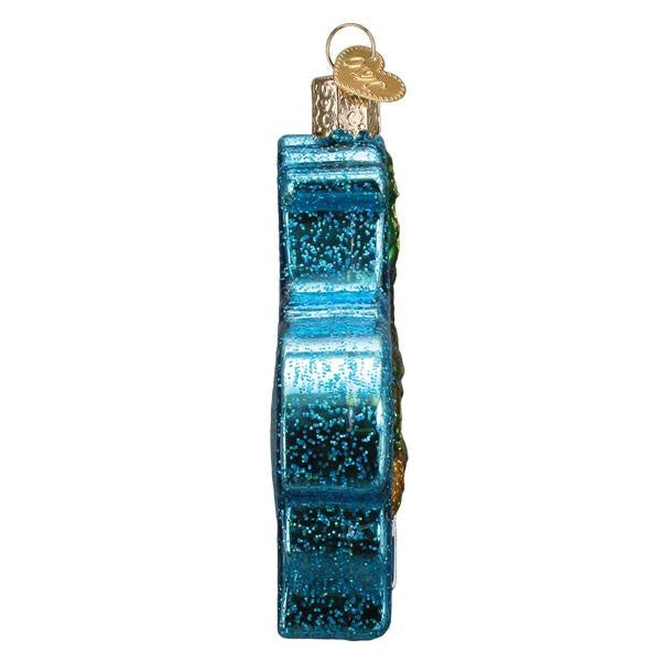 Side view of a Hawaiian Islands ornament featuring tropical island silhouettes in blue against white.