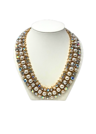 Three-strand gold necklace featuring white pearls and iridescent crystals on a white display bust.