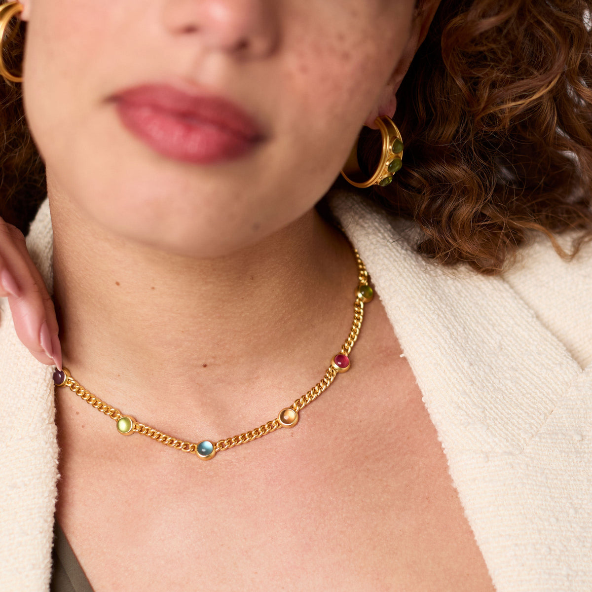 Close-up of a woman wearing the Dolce Delicate Station Necklace in 24K gold with colorful glass.