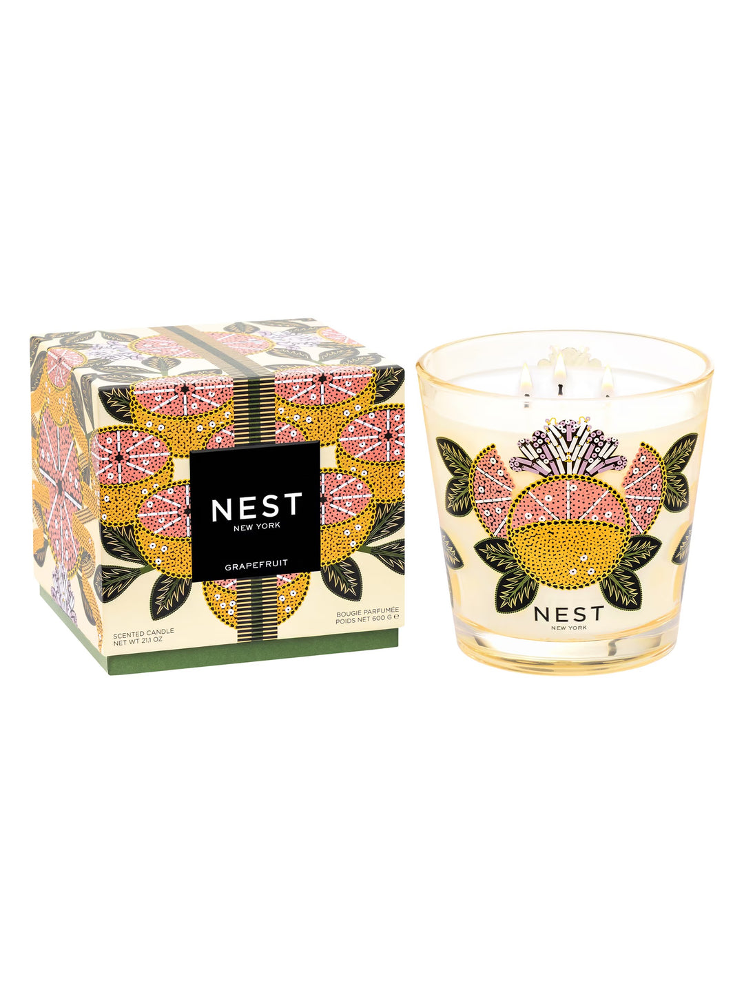 Nest Grapefruit 3-wick scented candle in a decorated glass jar next to its matching patterned box.