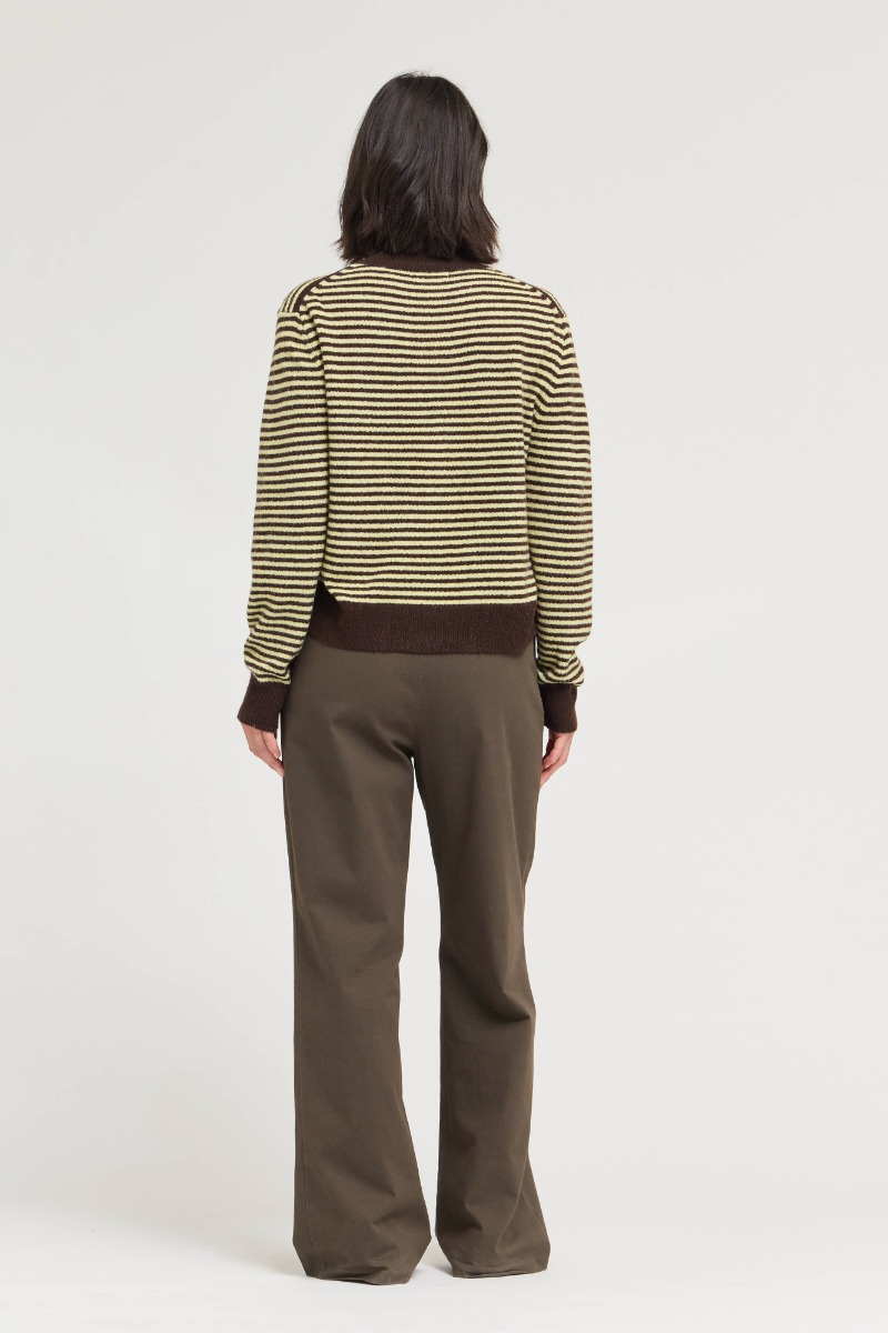 Back view of a woman wearing a brown and yellow striped Megan Mock Neck Sweater Cardigan.