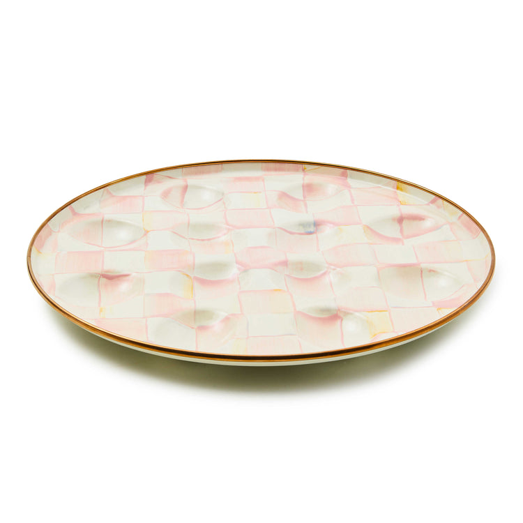 Round Rosy Check Egg Plate with hand-painted pink and white checks and bronzed stainless steel rim.