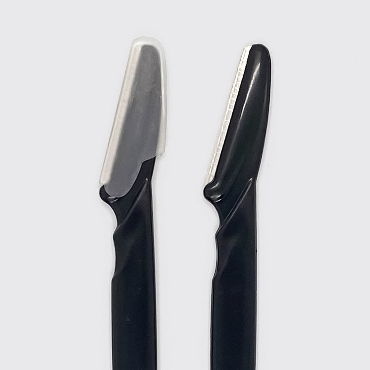 Black dermaplaner tool with a curved blade head designed for gentle skin exfoliation.