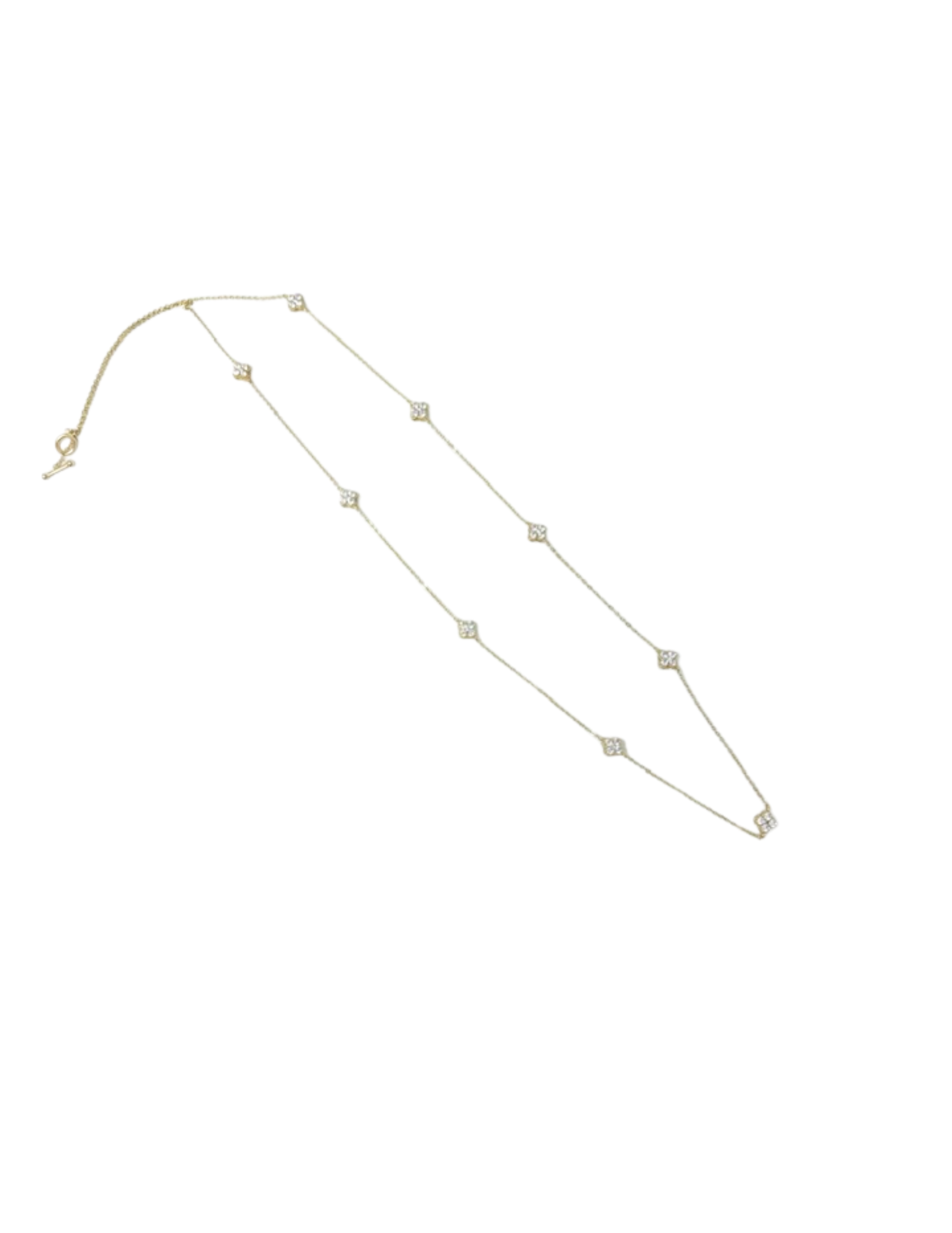 Gold chain necklace featuring multiple cubic zirconia clover-shaped stations.