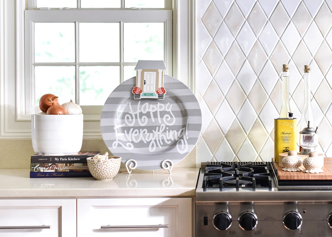House Welcome Big Attachment with a white door and pink flowers on a grey striped decorative plate.