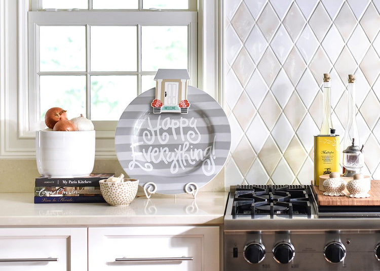 House Welcome Big Attachment with a white door and pink flowers on a grey striped decorative plate.