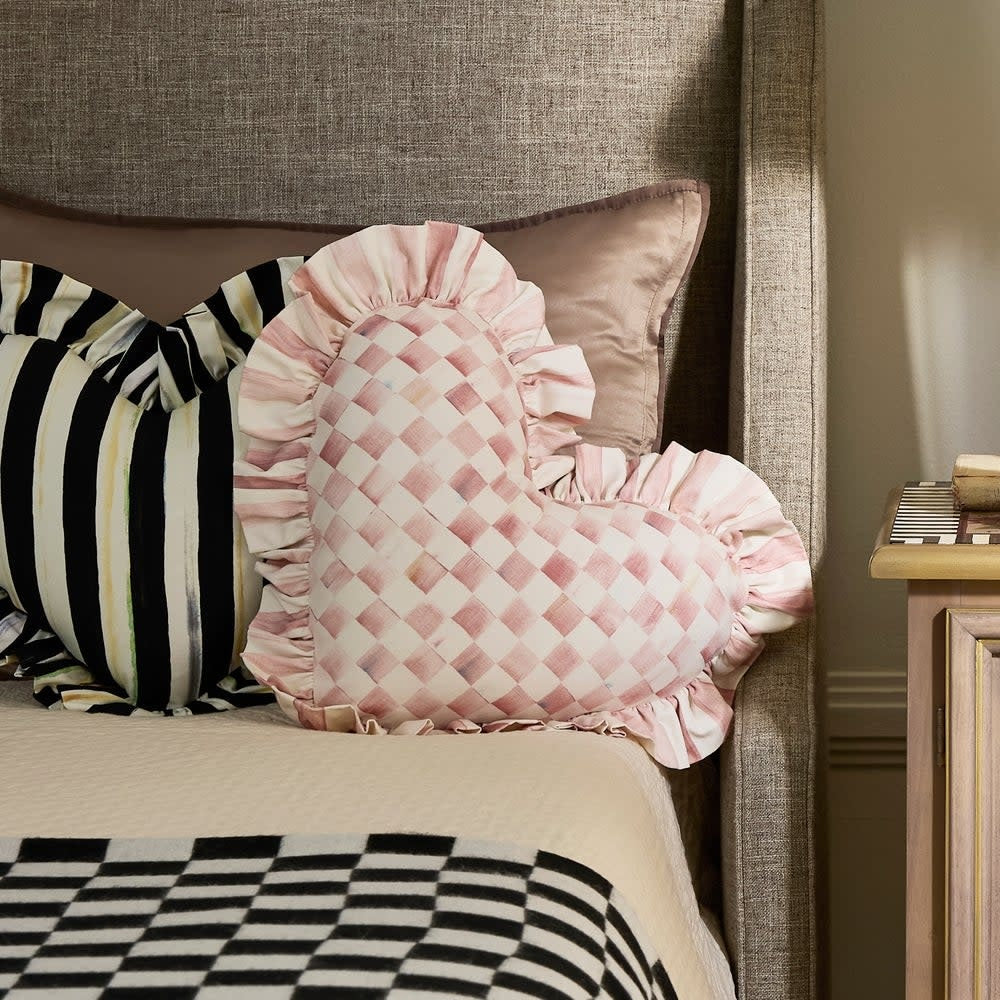Cotton heart-shaped throw pillow with ruffled edges in soft pink