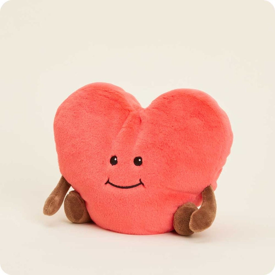 Plush heart-shaped weighted Warmie filled with dried French lavender in soft beige fabric.