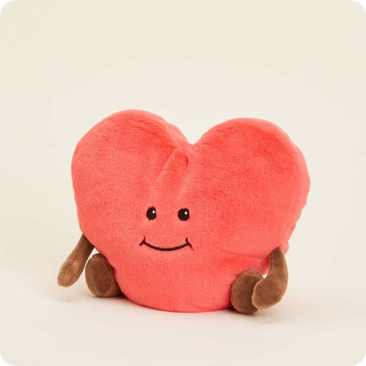 Plush heart-shaped weighted Warmie filled with dried French lavender in soft beige fabric.