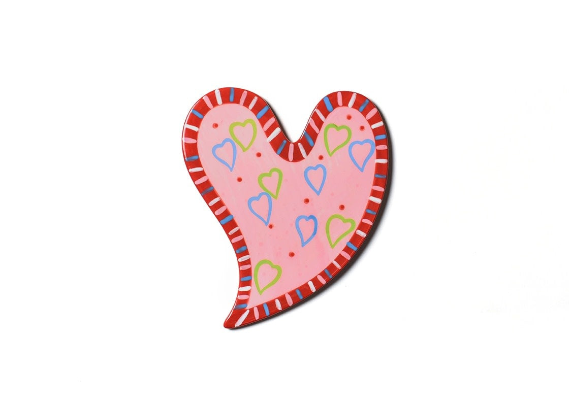 Ceramic heart-shaped wall attachment with polka dot accents in white.