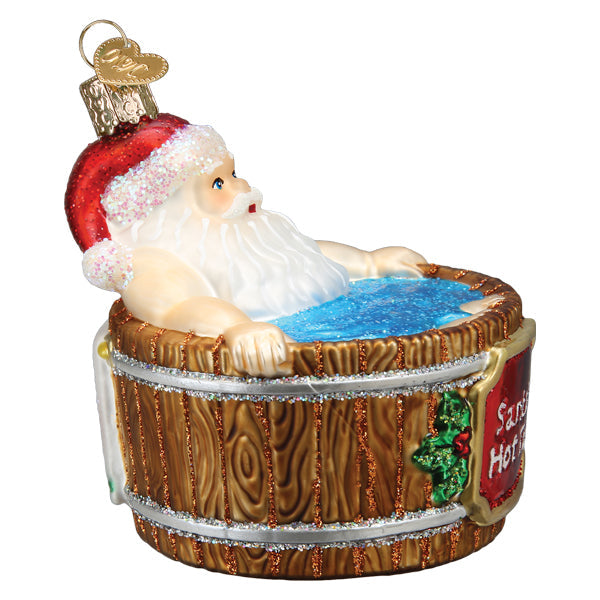 Santa Claus relaxing in a wooden hot tub glass Christmas ornament with glitter accents.