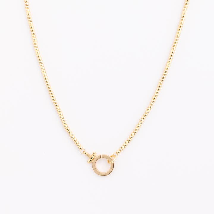 Gold beaded chain necklace with a circular spring ring clasp at the center.