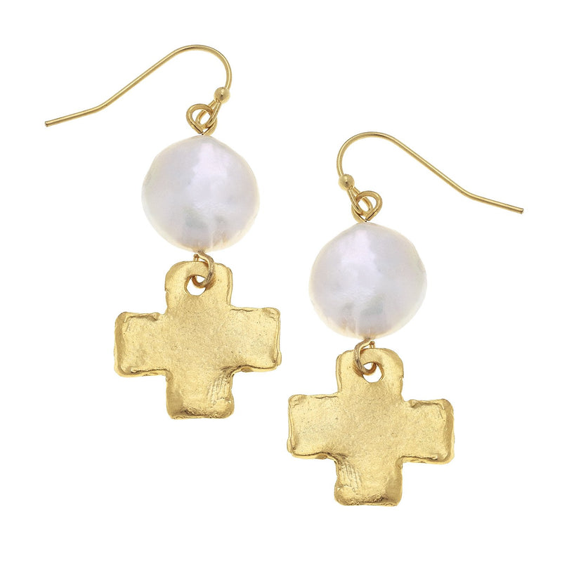 Gold fish hook earrings featuring a large white freshwater pearl and a textured gold cross charm.