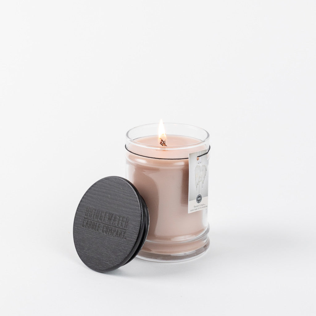 8oz Small Jar Sweet Grace candle in a clear glass jar with a lit wick and black wooden lid.