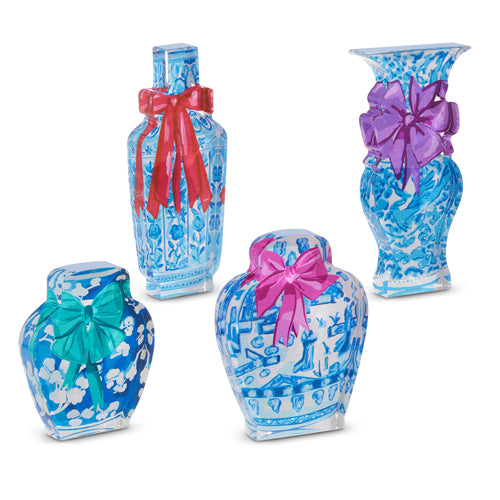 Four blue and white chinoiserie-style acrylic blocks shaped like vases with colorful bows.