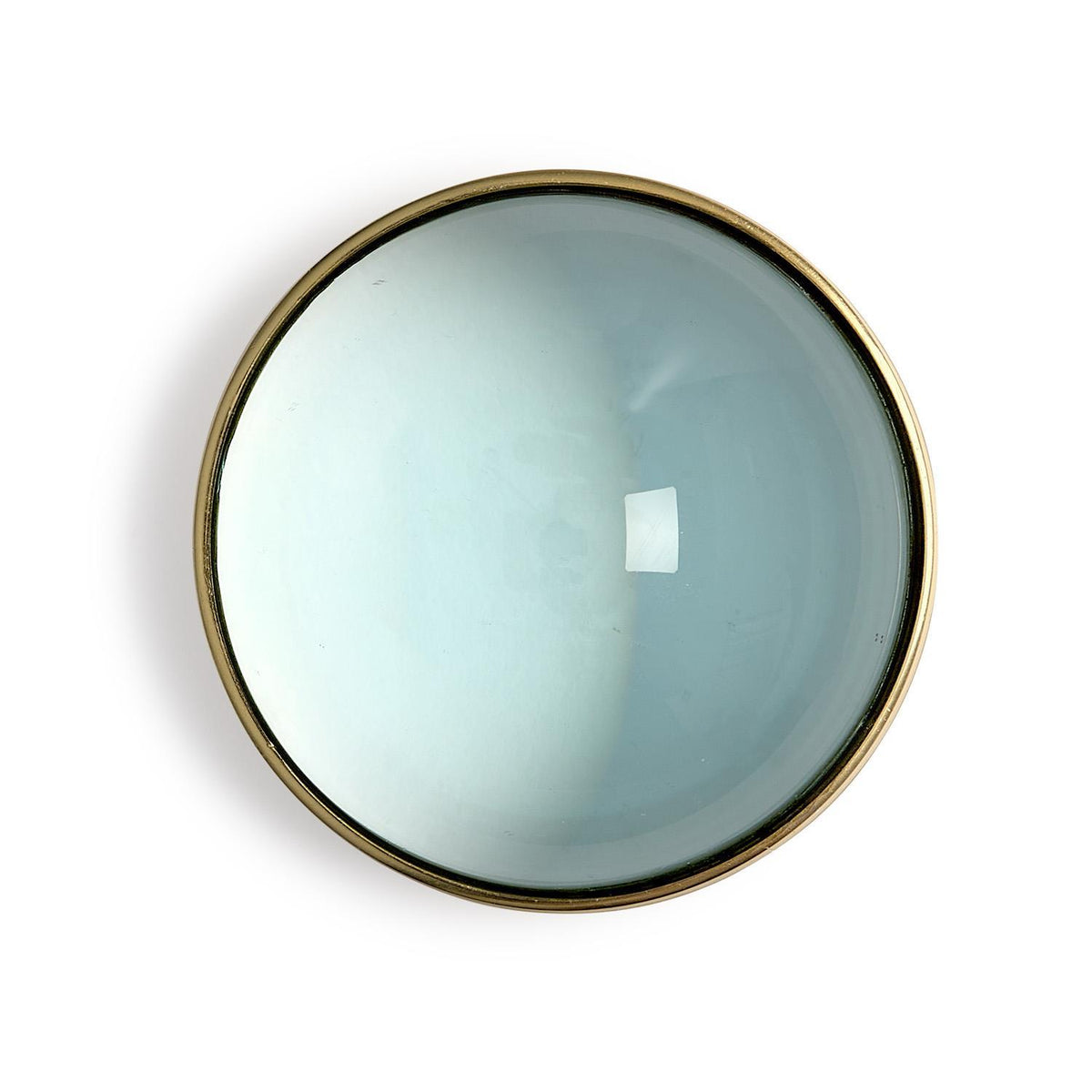 Top view of a dome concave lens desk top magnifier with a gold-toned metal rim.