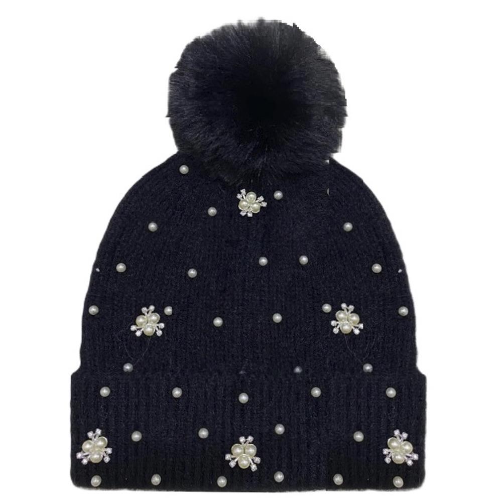 Black knit beanie with a fluffy pom-pom top and delicate pearl studs along the brim.