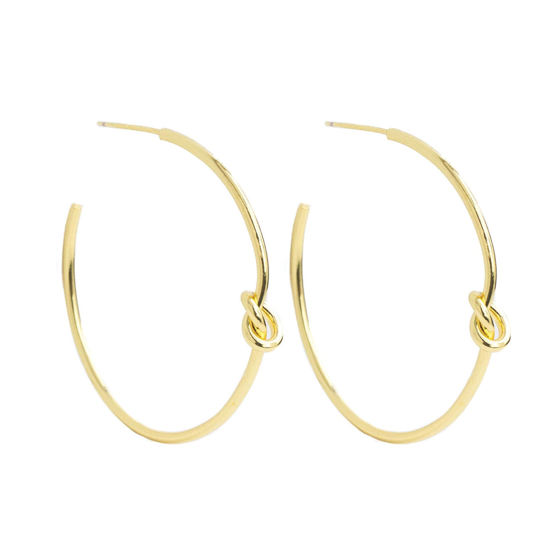 Pair of gold-colored delicate knot hoop earrings with a 1.5-inch drop.