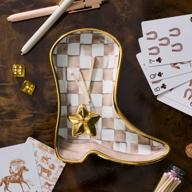Lainey Wilson x MC Mocha Check Cowboy Boot Dish with gold trim on a dark wood surface.