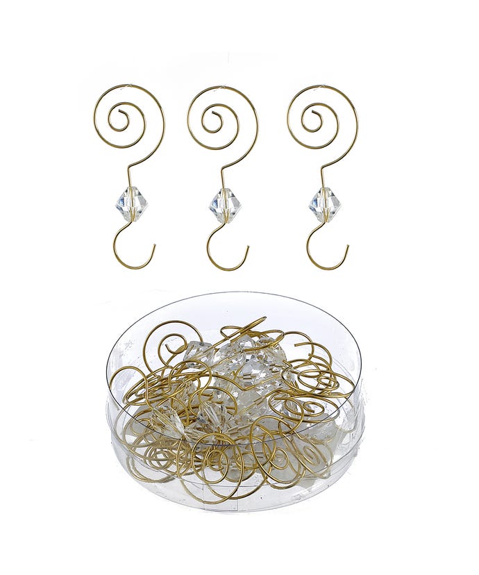 Three gold wire ornament hooks with clear acrylic beads above a container of more hooks.