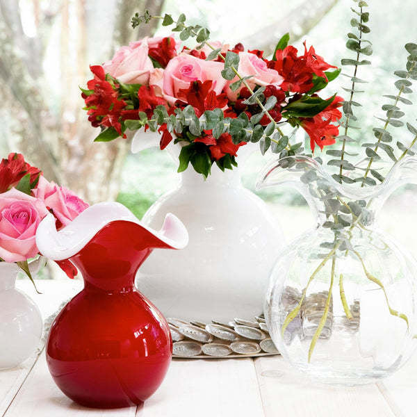 Medium fluted glass vase in clear hibiscus color with a tapered silhouette.