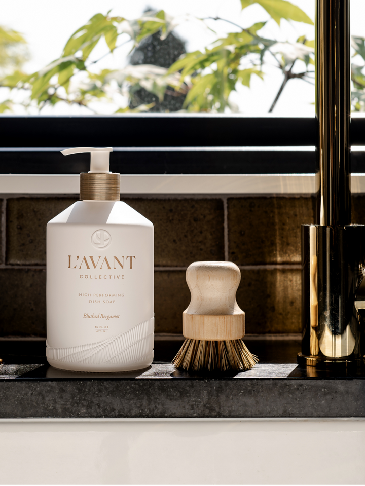Matte white glass bottle with gold pump containing Blushed Bergamot dish soap