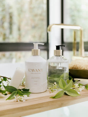 Refillable glass bottle with brushed gold pump neck containing plant-based dish soap