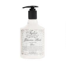 Bottle of Tyler Candle Company luxury hand wash in a clear glass container with white liquid and floral jasmine scent.