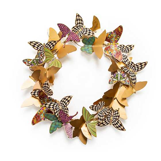Metal butterfly wreath with natural finish on a circular frame.