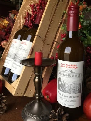 Bottle of McGowan's Old Tyme Wassail in a clear glass container with red and white holiday label design.