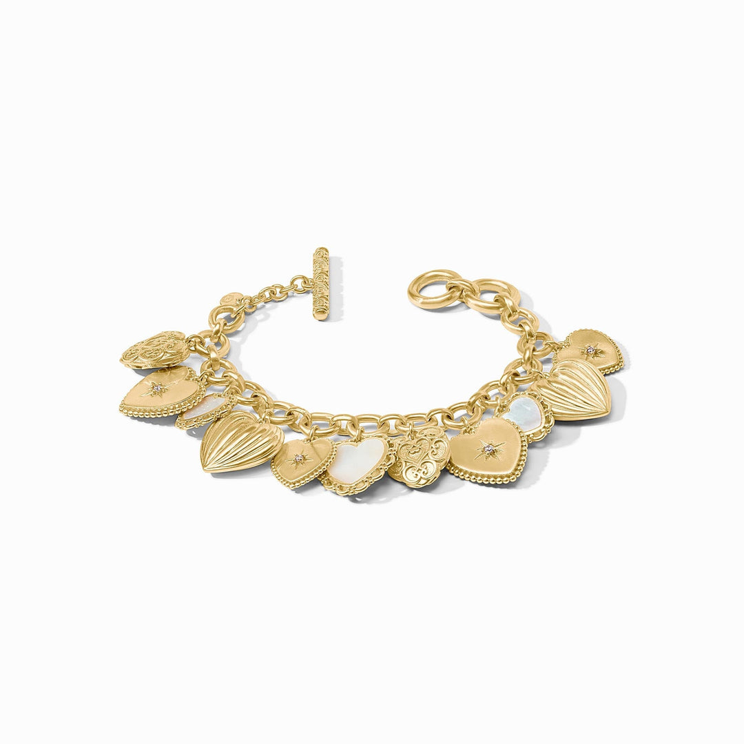Gold heart charm bracelet with mother of pearl and CZ accents, featuring a toggle closure.