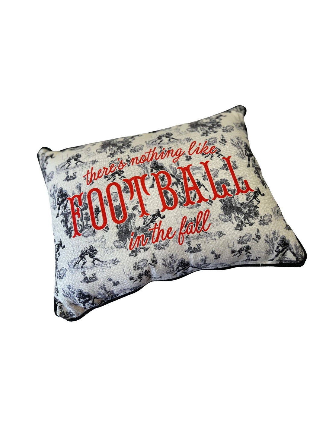 Rectangular pillow with black and white football toile pattern and red text reading Football.
