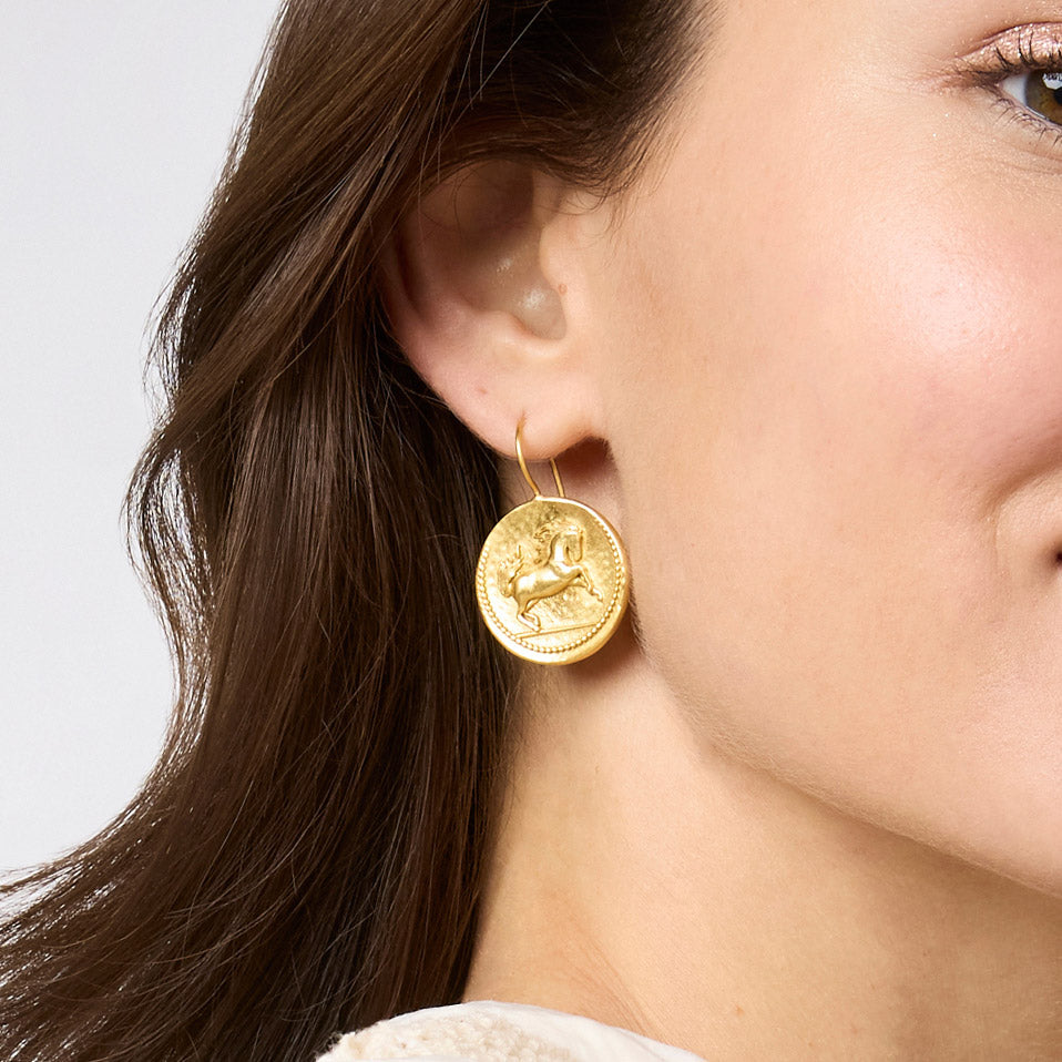 Gold-plated medallion earring featuring a prancing horse in bas relief with granulation details.