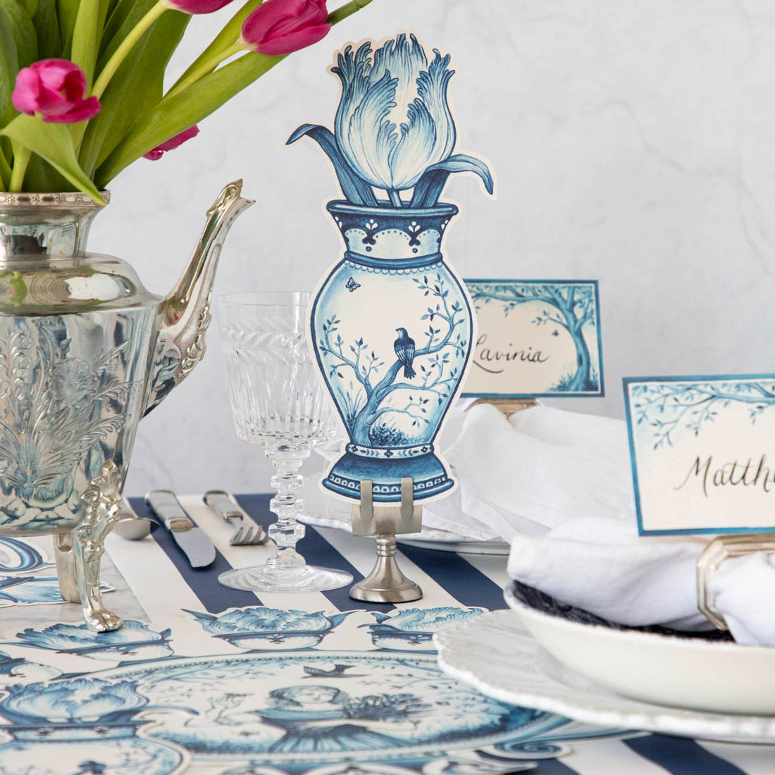 Indigo tulip-shaped table accent with a smooth curved silhouette.