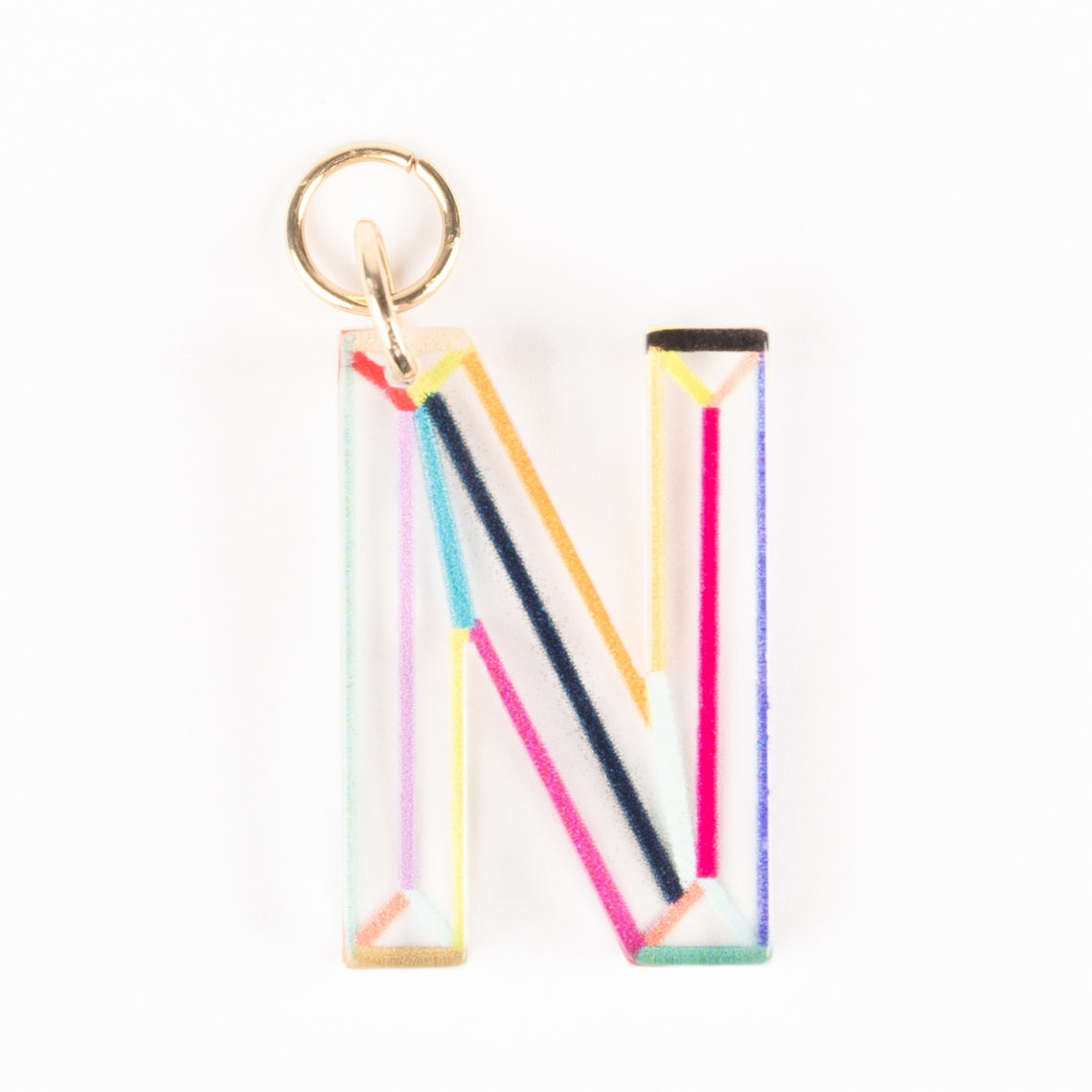 Marlow Initial Bag Charm featuring a clear acrylic letter N with colorful geometric line patterns.