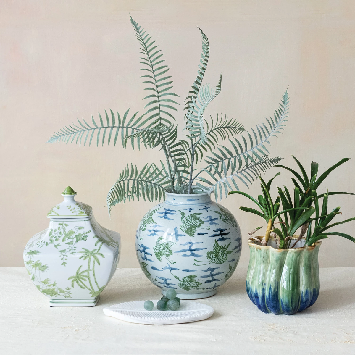 Round stoneware vase with a hand-painted crane motif on an off-white background.