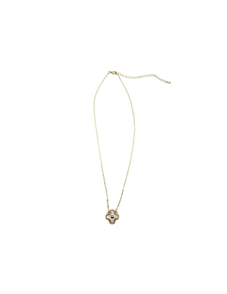 Gold chain necklace with a four-leaf clover pendant featuring clear cubic zirconia stones.