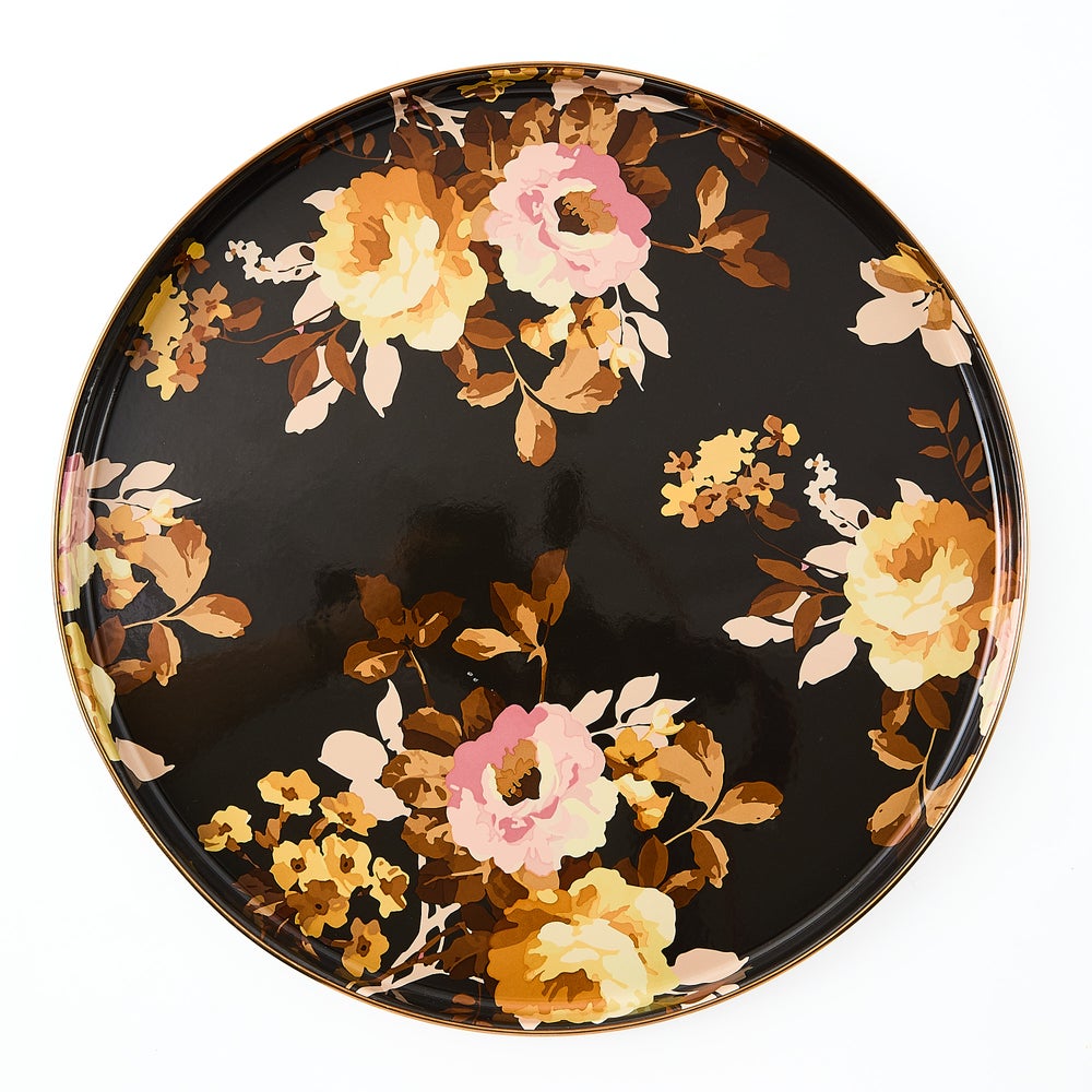 Round brown tray with hand-glazed steel surface, bronzed stainless rim, and floral transfer decoration.