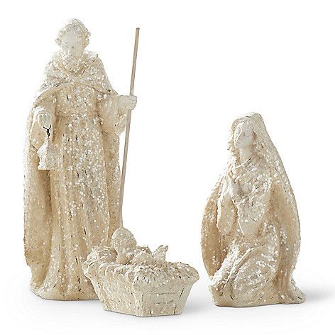 White resin nativity set with glitter finish featuring standing figures in a stable silhouette.